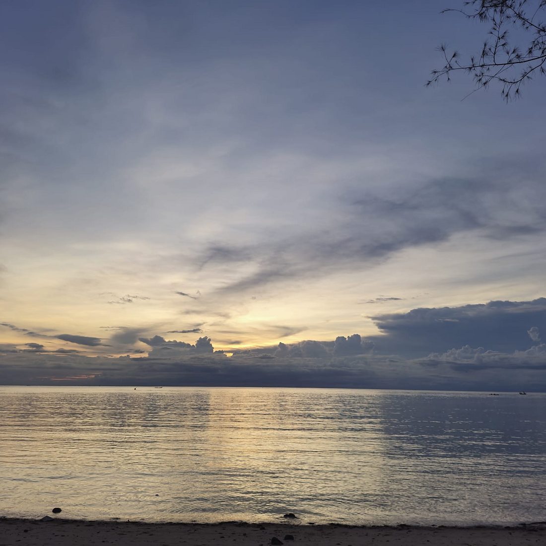 Golden light at dawn over a still sea